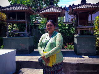 Woman With Traditional Balinese Clothes In The Family Temple House Yard At Ringdikit Village, North Bali, Indonesia