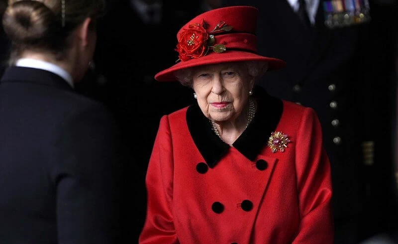 Queen Elizabeth wore a red coat, gold diamond brooch. HMS Queen Elizabeth and sister aircraft carrier HMS Prince of Wales