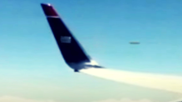 UFO Speed's Past Jet and caught on camera by plane passenger.