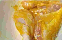 Marinated chicken pieces with turmeric powder and salt for chicken cafreal recipe