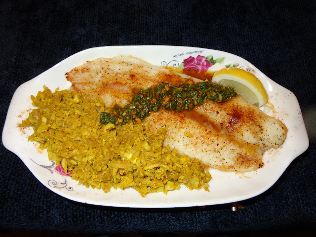 PORTIONS: 1 INGREDIENTS 6 oz. / 170g flounder filet ½ tbsp. butter ¼ tsp. paprika Salt and pepper to taste PREPARATION Melt the butter and mix with paprika, salt and pepper. Place the flounder in a baking dish, on top melted butter with the seasoning and broil it. CHERMOULA SAUCE ¼ tsp. saffron 2 tbsp. boiling water 1/3 cup chopped cilantro ¼ cup parsley 2 garlic cloves, minced 12 tbsp. ginger, minced ½ tsp. cumin powder 1 tsp. paprika ¼ tsp. coriander ¼ tsp. cayenne pepper 3 tbsp. olive oil 1 tbsp. lemon juice ¼ tsp. salt PREPARATION In a small dish place the saffron with the boiling water and let it rest while you cut and measure the other ingredients. In a bowl mix all the ingredients with the saffron. CAULIFLOUR RICE WITH MOROCCAN SPICES PORTION: 2 INGREDIENTS 3 cups shredded cauliflower 1 tbsp. olive oil 2 garlic cloves, minced ½ tbsp. ginger, minced 1 small onion diced ½ tsp. cumin powder ½ tsp. paprika ½ tsp. turmeric ⅛ tsp. cayenne pepper 1/4 cup water ¼ tsp. salt or to your own taste PREPARATION Heat a frying pan with the oil and sauté onions until transparent. Add the spices and cook for a few seconds. Add cauliflower, water and cook until hot. Do not overcook. Serve the fish with the chermoula sauce on center and cauliflower rice.