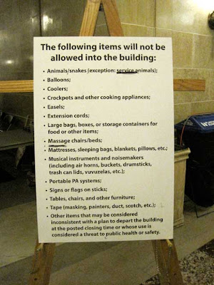 Large sign on an easel with long list of prohibited items