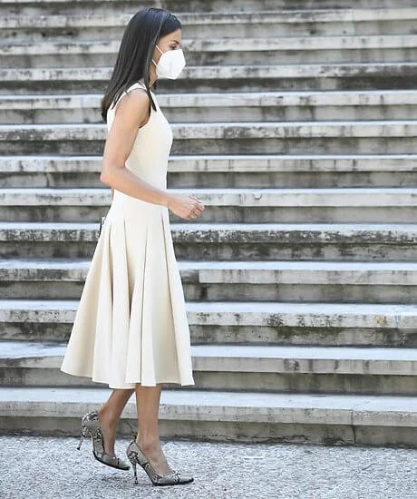 Queen Letizia wore an ivory midi dress by Spanish designer, Pedro Del Hierro, and snake printed pumps by Magrit. Gold And Roses earrings