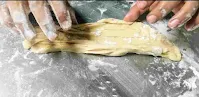 Folding dough sheet to make layered dough balls