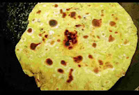 Light brown cooked Missi roti on pan