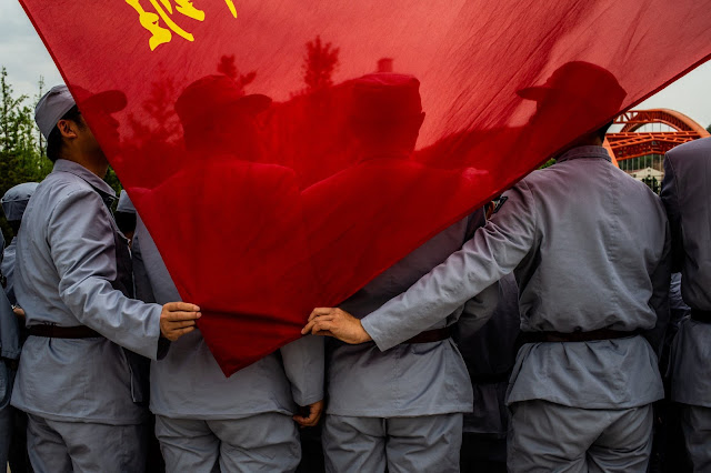 Chinese aerospace workers wearing Long March-style uniforms