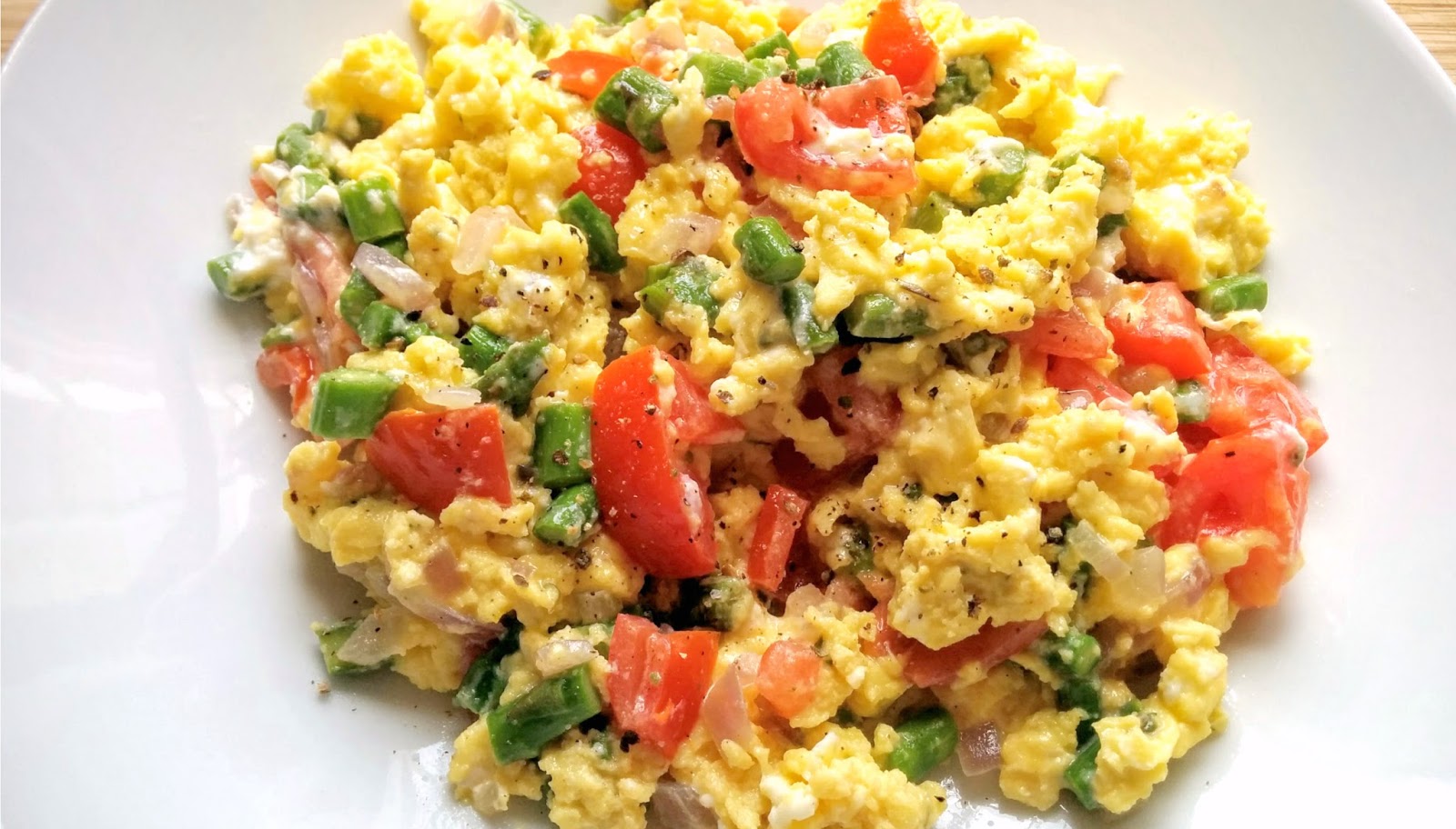Asparagus & Tomato Scrambled Eggs With Goat Cheese