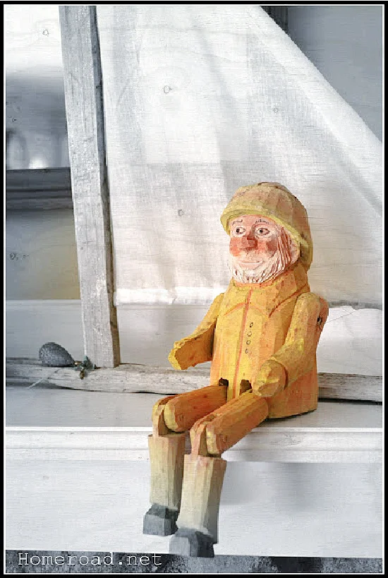 carved fisherman on the mantel