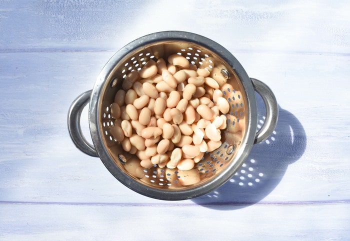 Cannellini beans in a metal colander