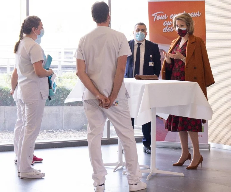 Queen Mathilde wore a new faux wrap cotton dress from Dries Van Noten, and a wool cahmere coat from Natan, and Natan pumps