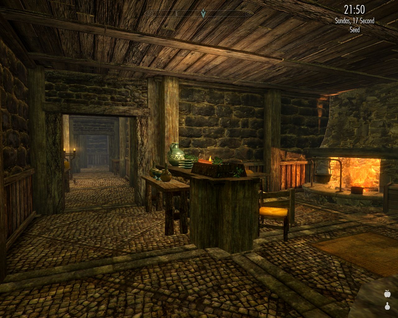 large room with stone walls and a fireplace, long corridor leads ahead apparently to several rooms