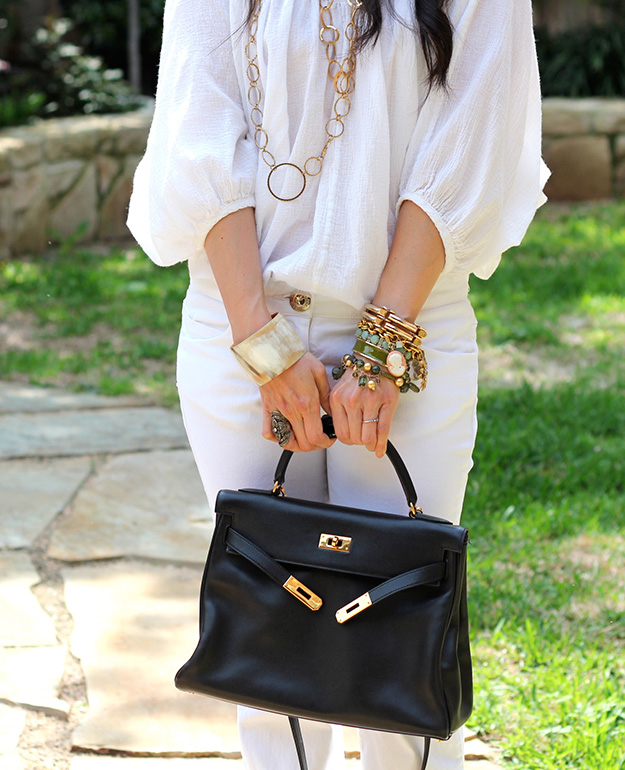 hermes kelly with summer white outfit and lots of bracelets