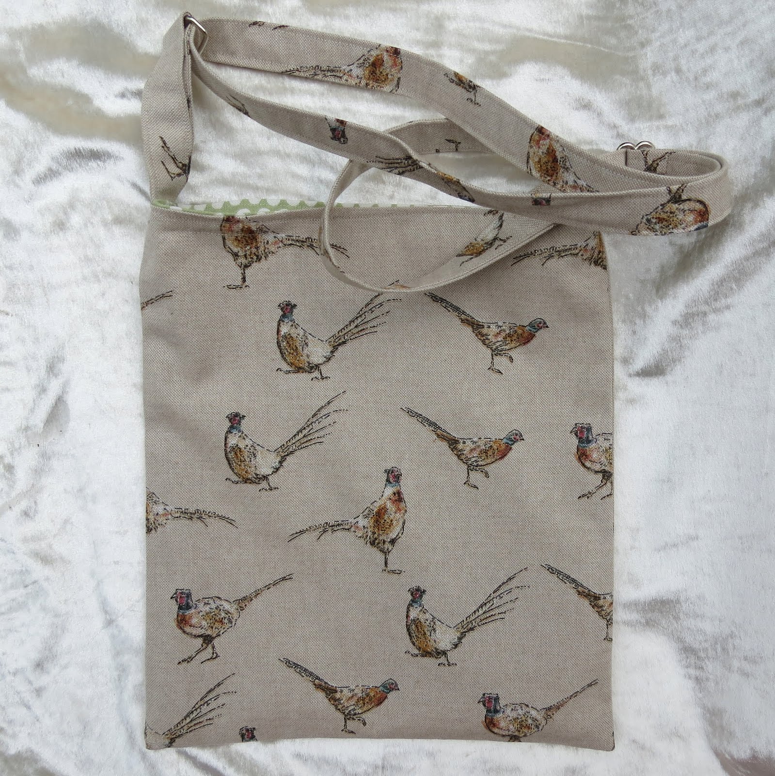 Drain bag.  A lined drain bag with an adjustable strap.  Pheasant design. Crossover drain bag.