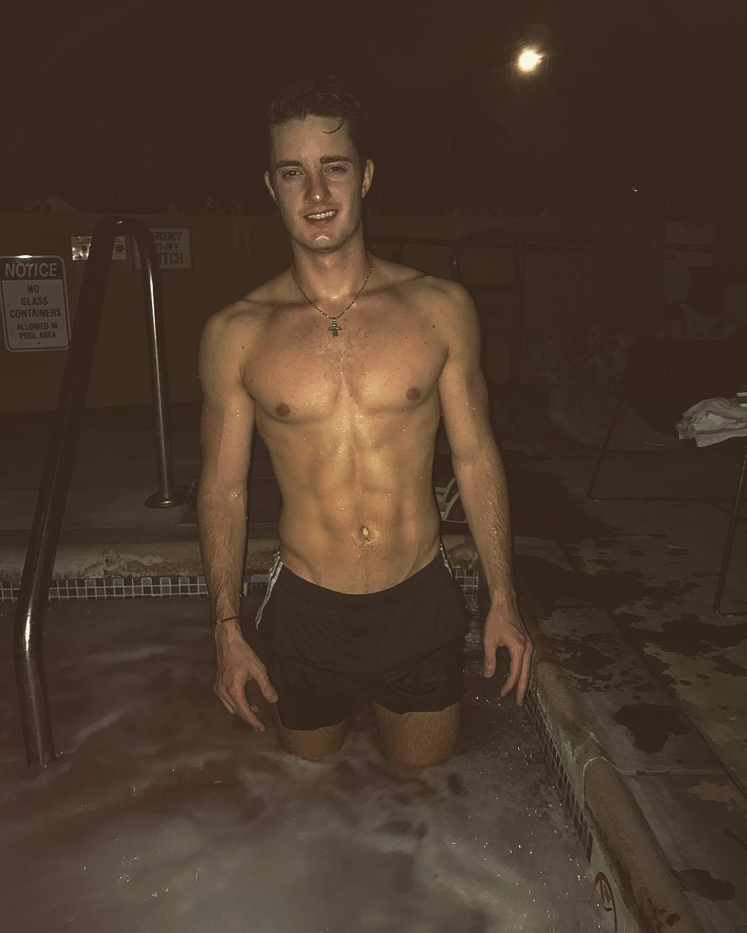 handsome-fit-young-shirtless-college-guy-smiling-hot-night-pool