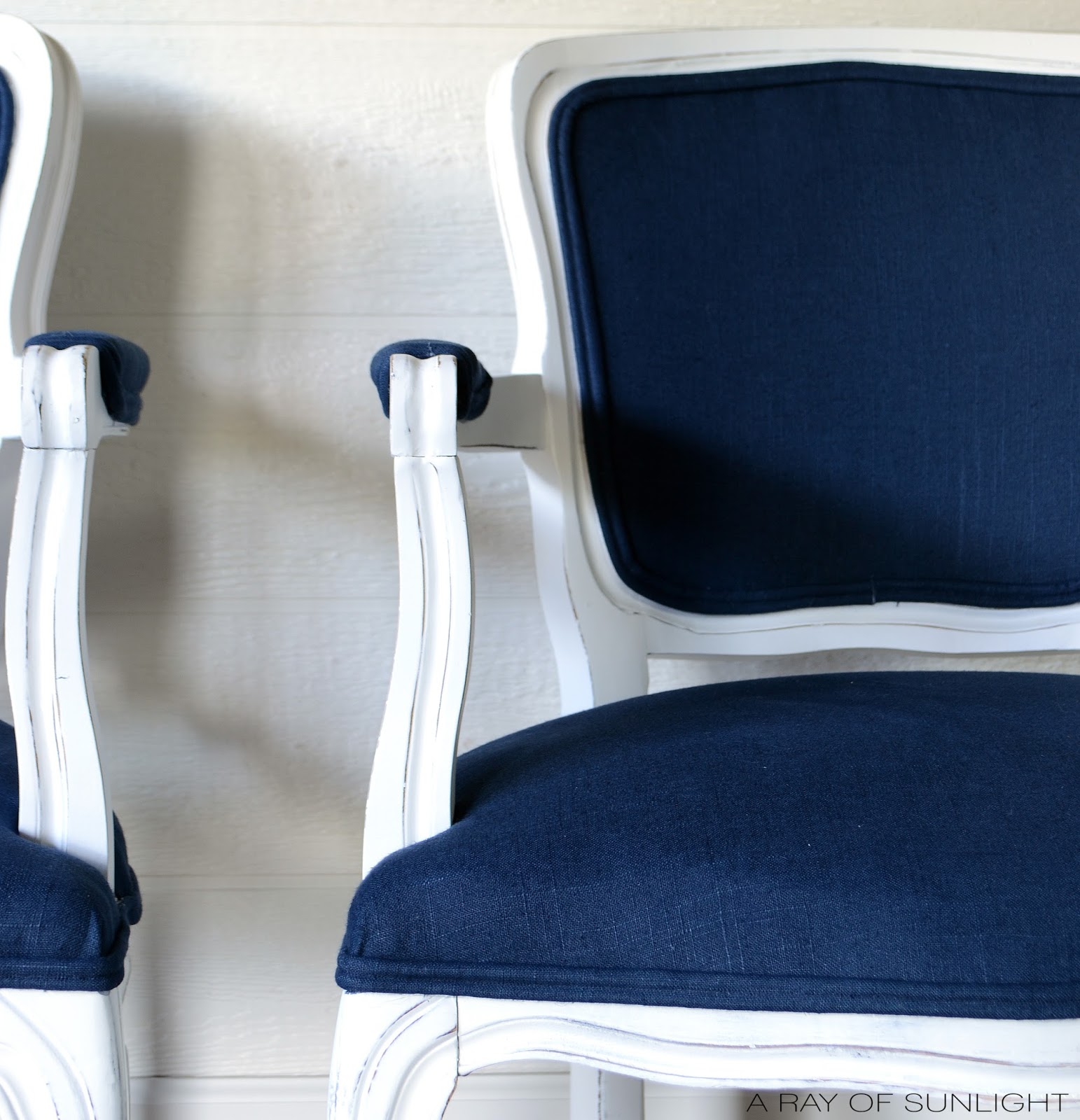 How to easily update old worn out thrift store chairs with some paint and fabric by A Ray of Sunlight Furniture. Love the navy blue and white makeover!