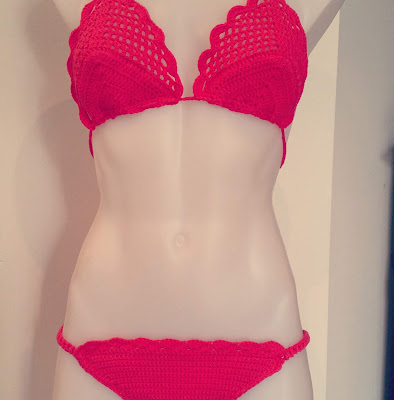 A photograph of the crocheted bikini modelled on the mannequin torso. The photo is cropped top and bottom. The bikini top is made with filet crochet lace with solid crochet for the cups. The bikini bottom is solid crochet with elasticised sides. Both top and bottom are embellished with shell patterns.