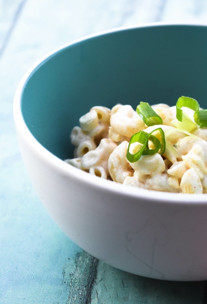 Creamy cheesy pasta salad in a blue bowl