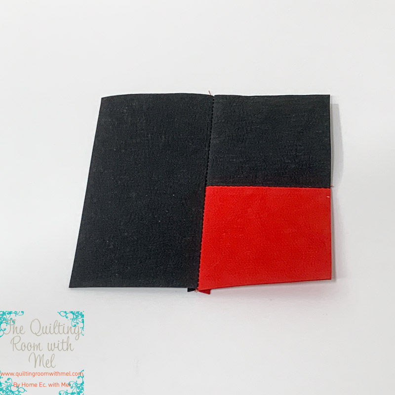 The first unit of the crossroads wall hanging with kraft tex faux leather in crimson and black