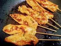 Crisp and roasted chicken pieces on pan for chicken satay recipe