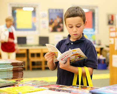 child looking at books