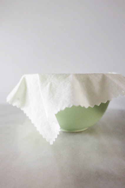 reusable environmentally friendly beeswax wrap atop bowl