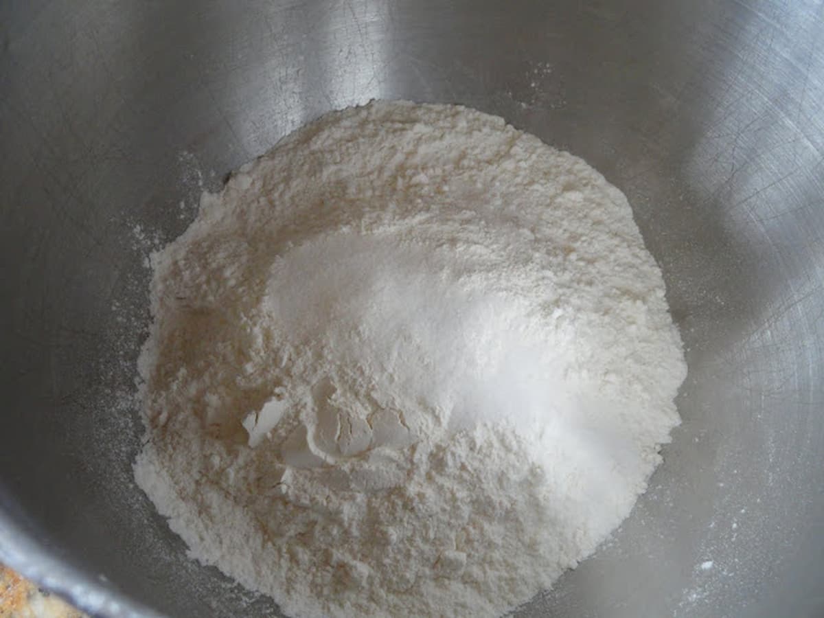 Flour and Salt in a stainless steel mixing bowl.