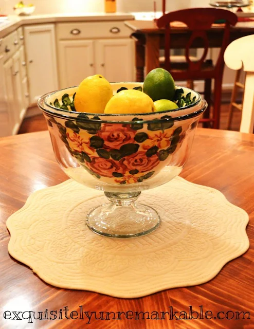 Lemons and limes in floral bowl on a table