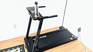 A slightly bird's eye view of the Altrax Fitness AX-T10 motorized treadmill in a home.