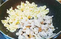 Adding bite size Chicken pieces with scrambled eggs for making chicken fried rice recipe