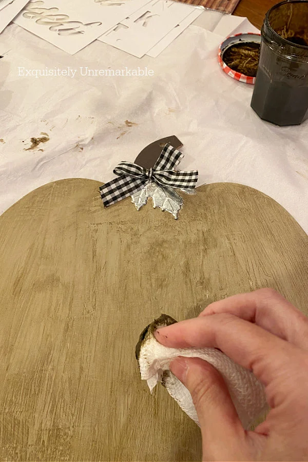 Wiping Stain Off A Pumpkin shape with paper towel