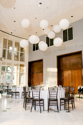 wedding reception white tables and black chairs