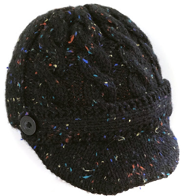 Cabled hat with brim and front strip knitted with black tweed yarn
