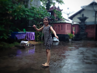 Sweet Little Girl Playing In The Rain In The House Yard North Bali Indonesia