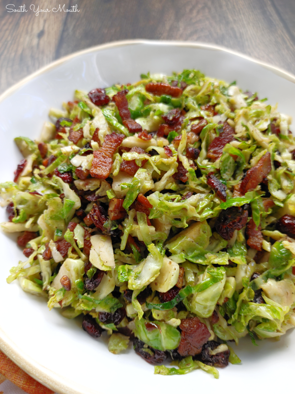 Craisin Bacon Shredded Brussels Sprouts! Thinly sliced brussels sprouts sautéed with crispy bacon, toasted crunchy pecans and sweet, tangy dried cranberries makes a perfect side dish recipe for Thanksgiving or Christmas dinner!