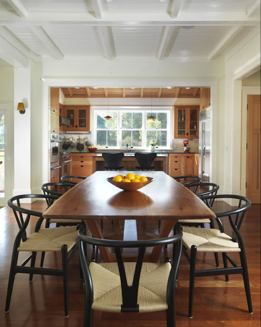 Black Oak Wishbone Chairs with Natural Papercord Seats are used in this transitional kitchen and dining room (Architecture by Union Studio, Architecture and Community Design).
