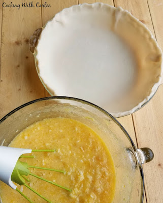 bowl of filling ready to be poured into waiting pie crust