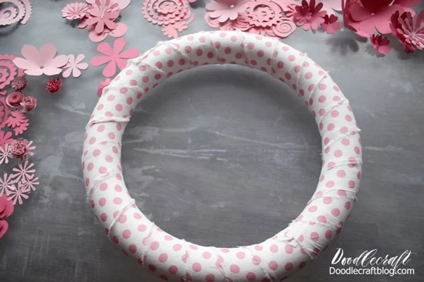 Use the hot glue gun to wrap and glue the fabric around the wreath form.