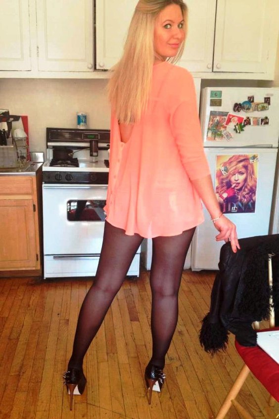 Sexy woman wearing a mini dress, black tights and black pumps high heels