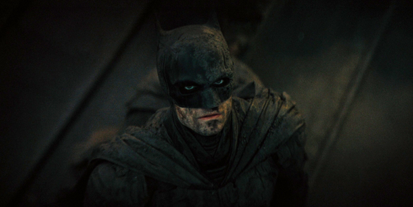 Bruce Wayne (Robert Pattinson) is battle-worn as the Dark Knight Detective in 2022's THE BATMAN.