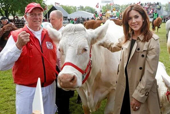 Crown Princess Mary wore a Ralph Lauren double breasted trench coat, a velvet trousers, and a sweater at agricultural and livestock fair