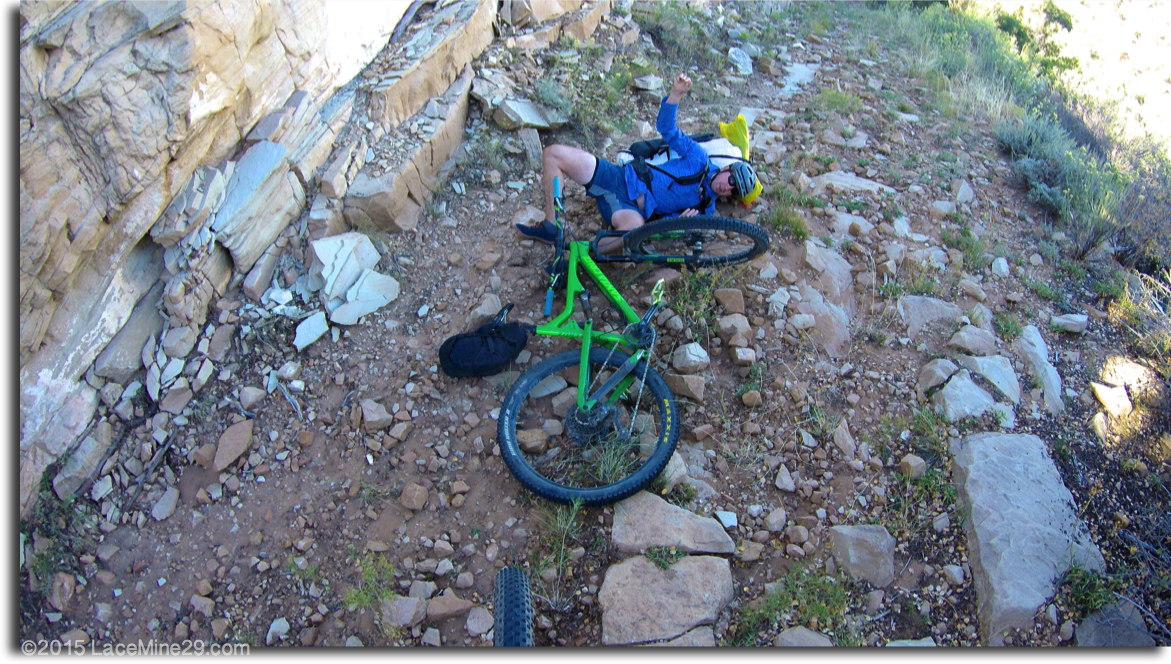 biker laying under bike after a fall