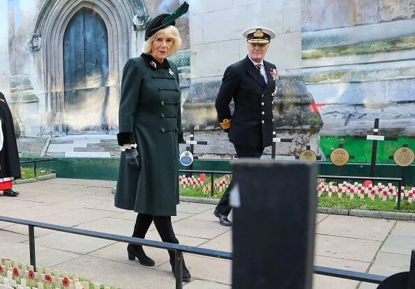 The Duchess of Cornwall wore a green wool coat at Westminster Abbey. The Duchess in a recycled green coat, and a poppy facemask