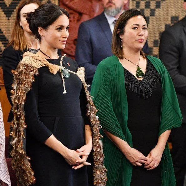 Duchess of Sussex wore Stella McCartney navy asymmetric crêpe dress. Kiri nathan Pounamu Kouma, carved by Jason Nathan