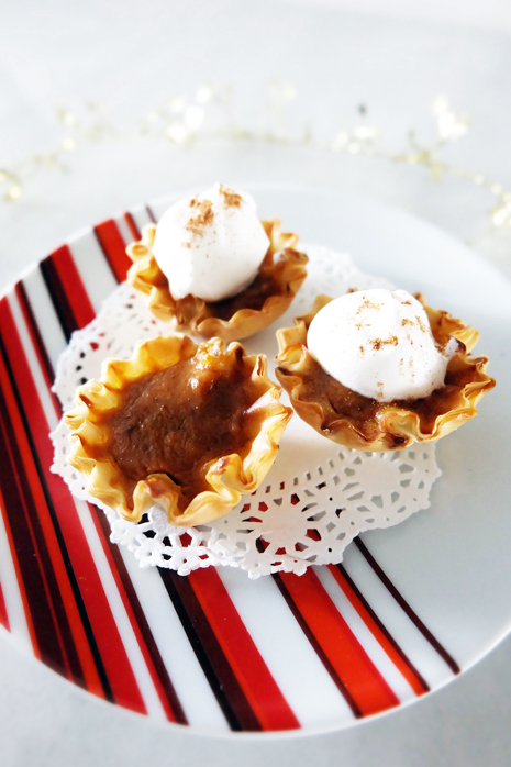 mini pumpkin pies with whipped cream on plate