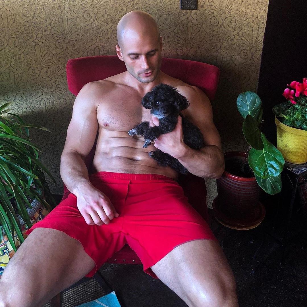 fit-bald-shirtless-hairy-daddy-masculine-dilf-huge-thighs-holding-puppy-dog