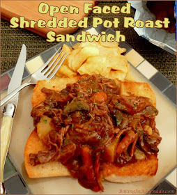 Get out your fork and knife for this Open Faced Shredded Pot Roast Sandwich. The tender roast is slow cooked in the crock pot with vegetables, shredded and served over toasted Italian bread. | Recipe developed by www.BakingInATornado.com | #recipe #crockpot