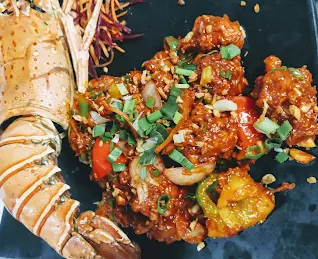 Serving lobster meat with sauce and vegetables for lobster in hot garlic sauce recipe