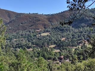 A panoramic view of the site from a nearby hillside.