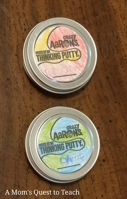 two tins of Thinking Putty® with labels decorated 