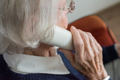 old woman on a phone call with a loved one
